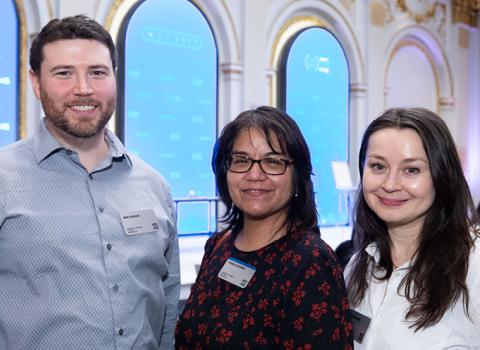 Three W. P. Carey employees at the New York Stock Exchange celebrating WPC's 25 years as a publicly traded company