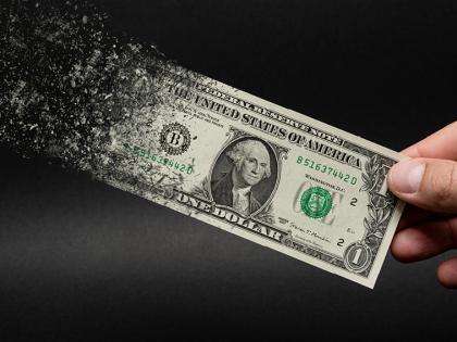 Dollar bill turning to dust