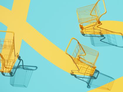 Three yellow shopping carts move across a teal space leaving yellow tracks
