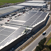CareySolar solar panels on an industrial facility, representing W. P. Carey's inaugural green bond offering