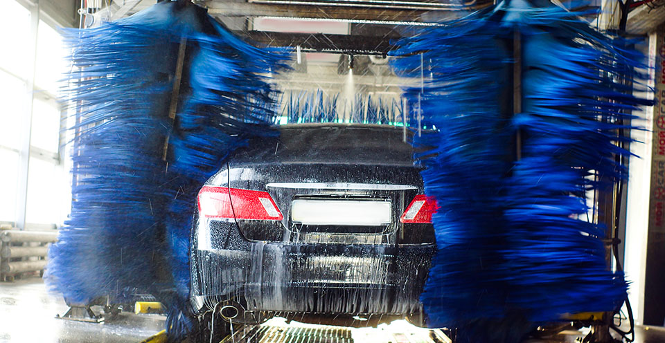 Black car going through a car wash