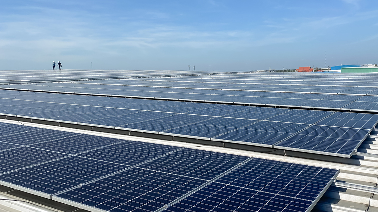 Construction workers standing on solar panels