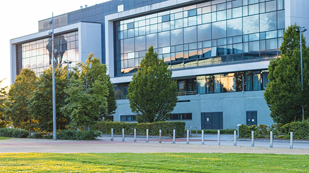 The outside of a building with bright green grass