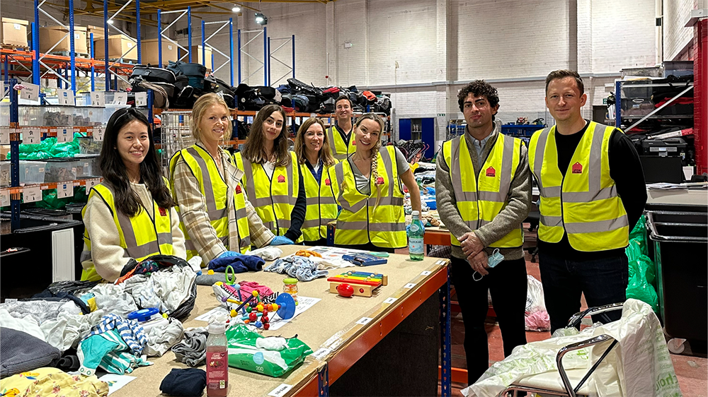 The W. P. Carey London team at a charity event, wearing high-vis vests