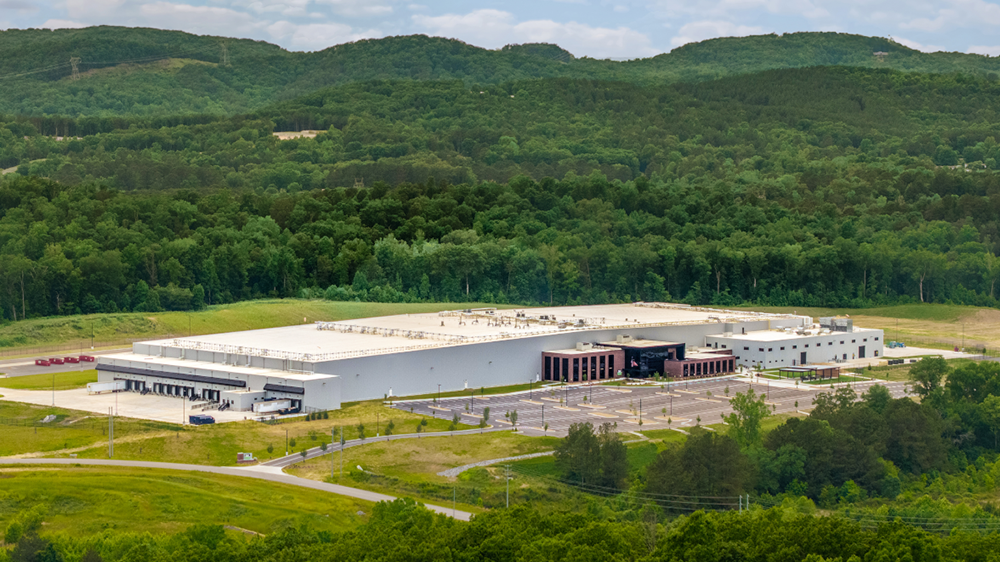 Exterior photos of a WPC owned facility amongst lush green tree-topped hills