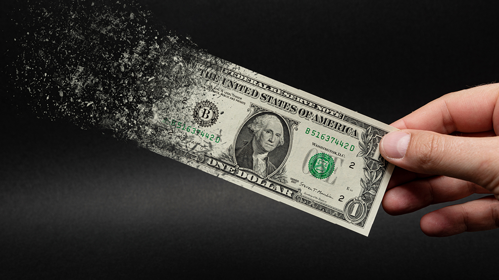 Image of dollar disintegrating to signify inflation