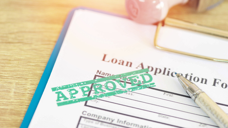 Loan application form with stamping that says “Loan Approved"