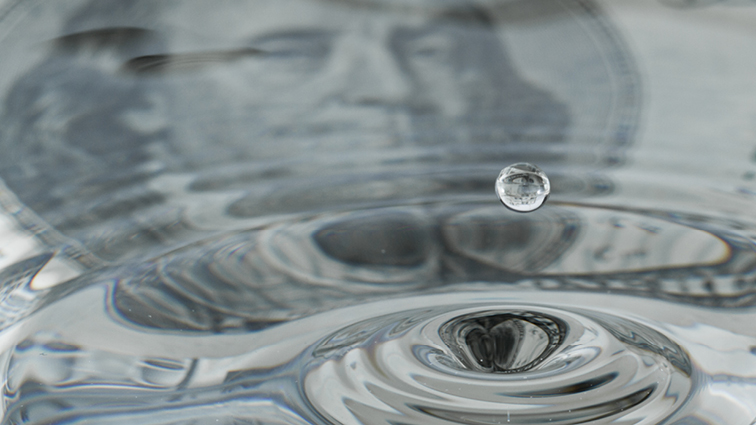 conceptual image of money and water droplets