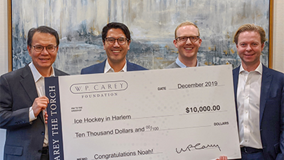 John J. Park, Will Carey and Jason E. Fox of W. P. Carey with the first winner of Carey the Torch in 2019