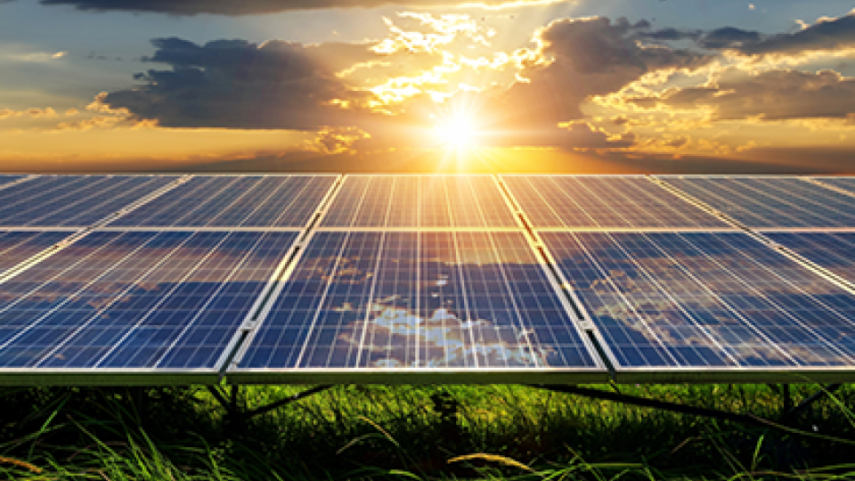 The sun rising on solar panels