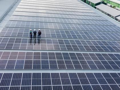 Construction workers standing on solar panels