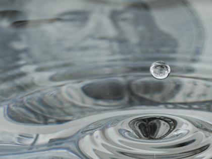 Dollar bill reflected in leaking water