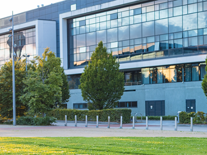 The outside of a building with bright green grass