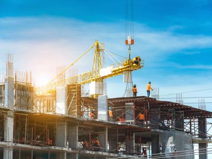 Photo of building under construction with people