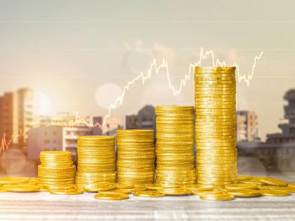 Photo of coin stacks with buildings behind it