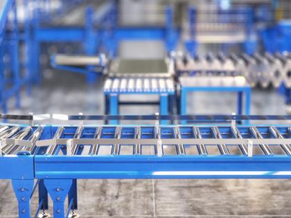 Stock photo of a clean, blue and chrome empty processing machine in a factory