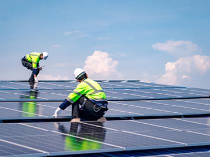 Photo of people working on solar roof