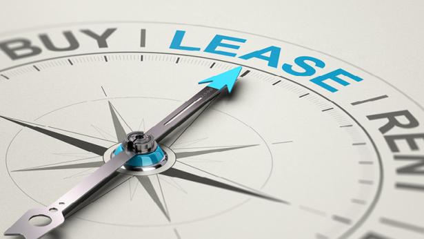 Image of compass pointing toward the word lease to represent being guided to a sale leaseback