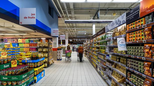 Photo of aisle in grocery store with people