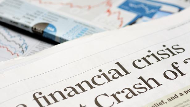 Image of article in newspaper with financial crisis in headline