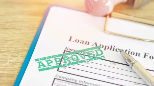 Loan application form with stamping that says “Loan Approved”