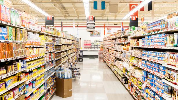 Image of grocery store aisle with food to represent the resilience of core-good retailers and service-based tenants post COVID-19