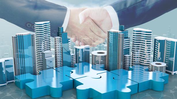 Image of buildings and people shaking hands