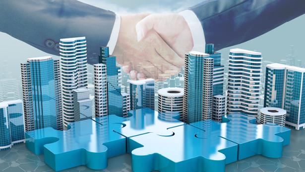 Image of buildings and people shaking hands