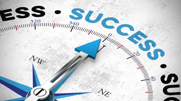 Image of compass pointing toward the word success 