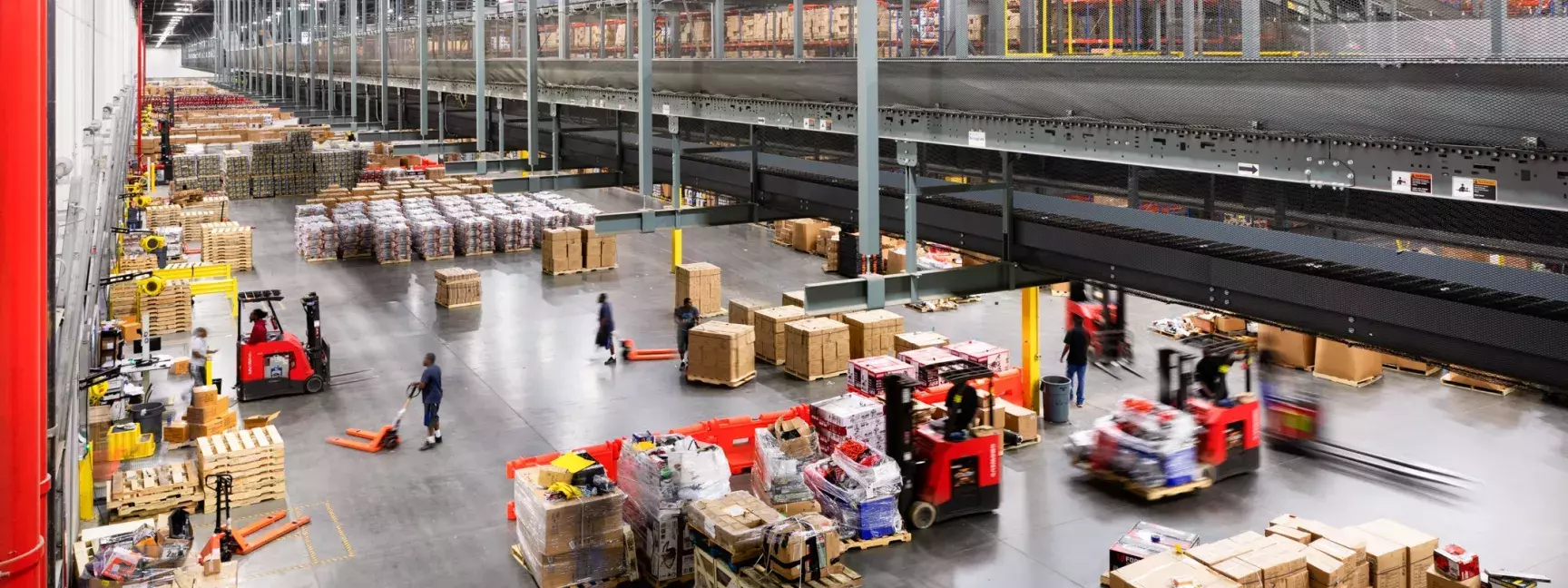 Inside a busy warehouse with lots of cardboard boxes and employees, owned by W. P. Carey