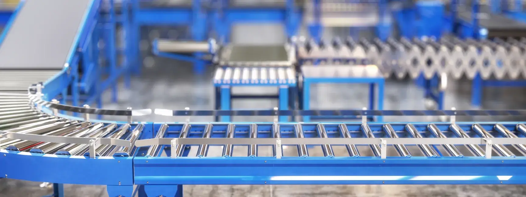 Stock photo of a clean, blue and chrome empty processing machine in a factory