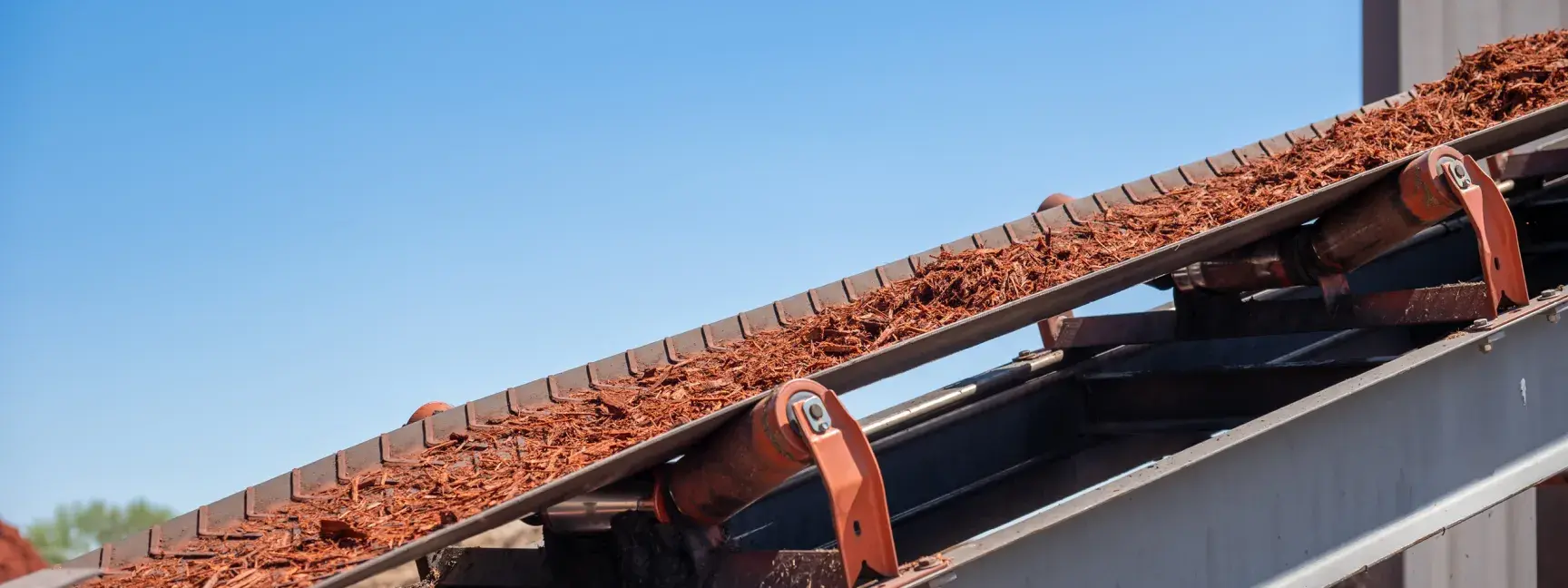 Machinery with wood chips flowing down