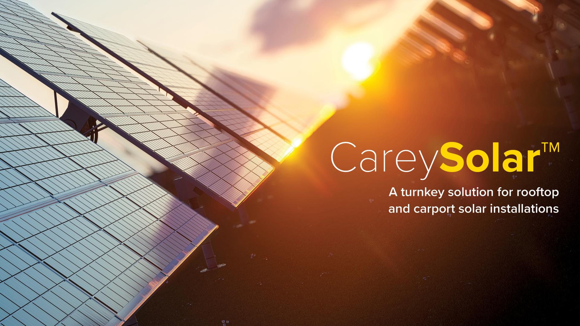 Light from the sunrise streaming over solar panels with the logo for CareySolar in front to represent the power behind going green and installing solar panels.